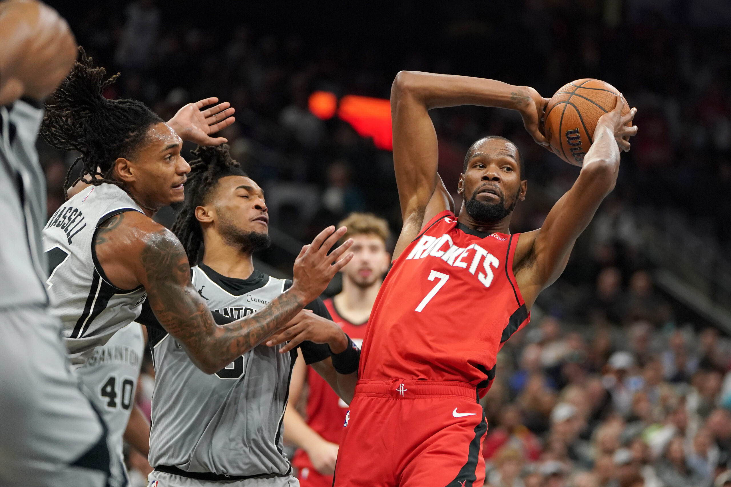 Nov 7, 2025; San Antonio, Texas, USA; Houston Rockets forward Kevin Durant (7) passes against San Antonio Spurs guard Stephon Castle (5) and guard Devin Vassell (24) during the second quarter at Frost Bank Center. Mandatory Credit: Dustin Safranek-Imagn Images