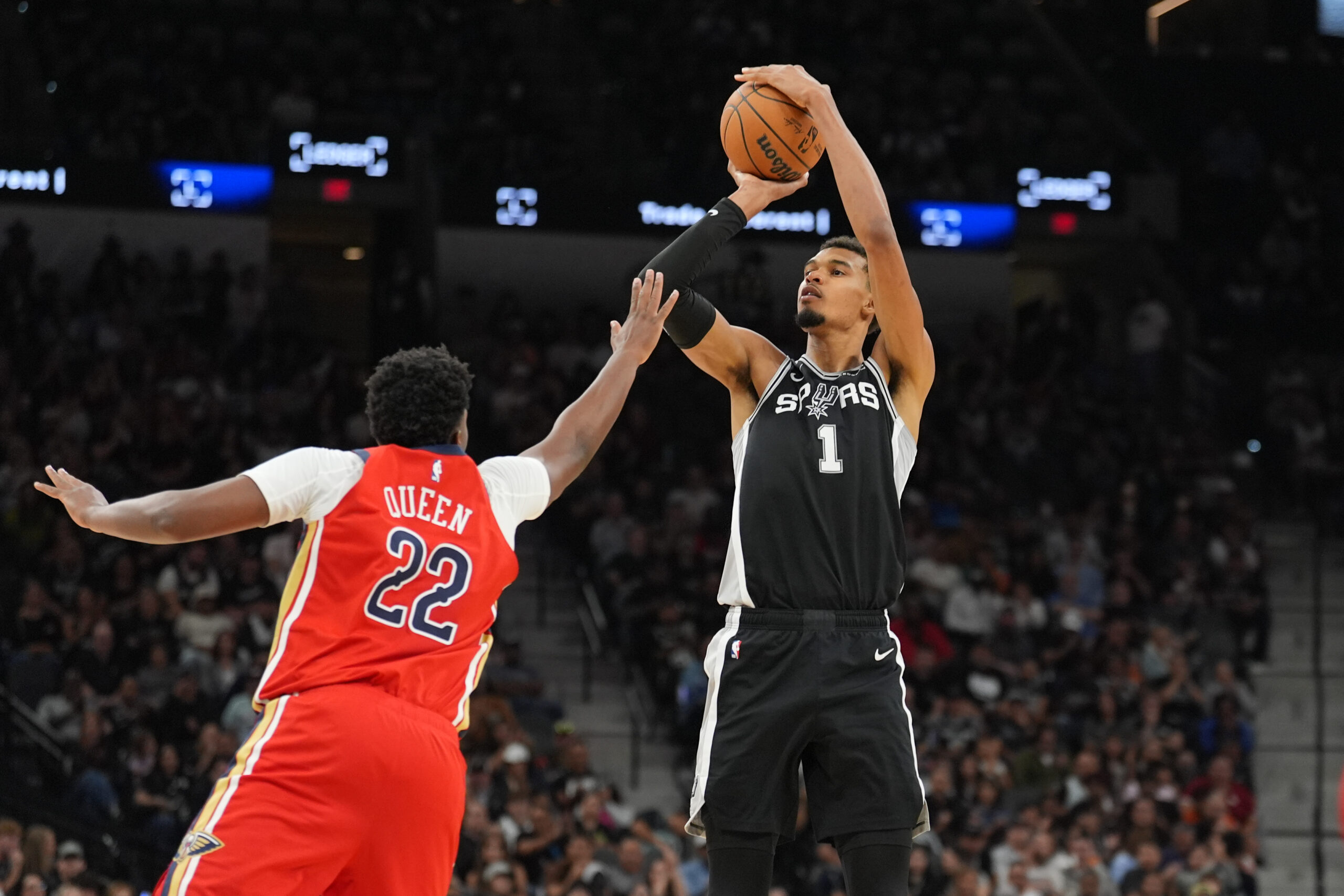 Nov 8, 2025; San Antonio, Texas, USA; San Antonio Spurs forward Victor Wembanyama (1) shoots over New Orleans Pelicans center Derik Queen (22) in the second half at Frost Bank Center. Mandatory Credit: Daniel Dunn-Imagn Images
