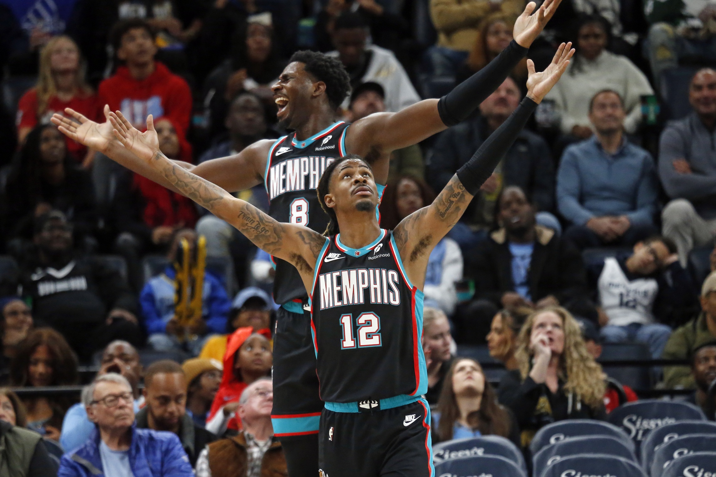 Nov 9, 2025; Memphis, Tennessee, USA; Memphis Grizzlies forward/center Jaren Jackson Jr. (8) and guard Ja Morant (12) react during the third quarter against the Oklahoma City Thunder at FedExForum. Mandatory Credit: Petre Thomas-Imagn Images