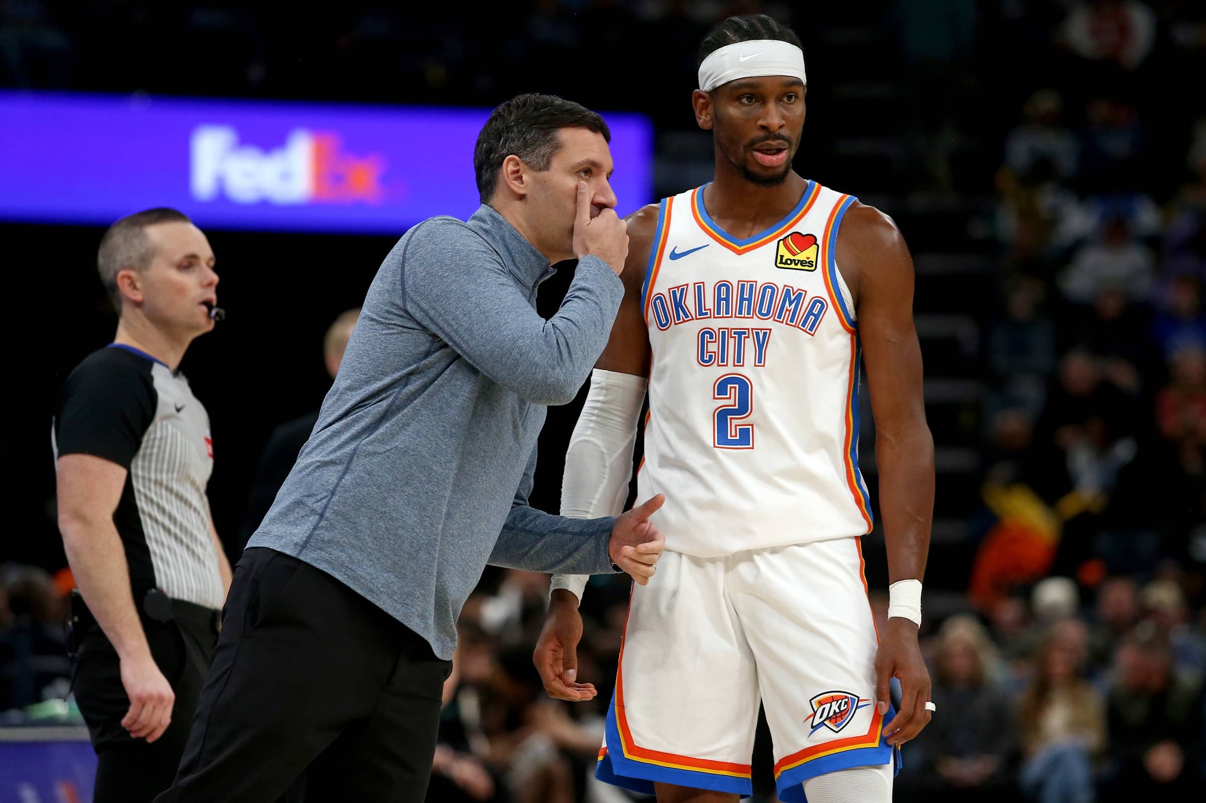 Nov 9, 2025; Memphis, Tennessee, USA; Oklahoma City Thunder head coach Mark Daigneault talks with guard Shai Gilgeous-Alexander (2) during the third quarter against the Memphis Grizzlies at FedExForum. Mandatory Credit: Petre Thomas-Imagn Images
