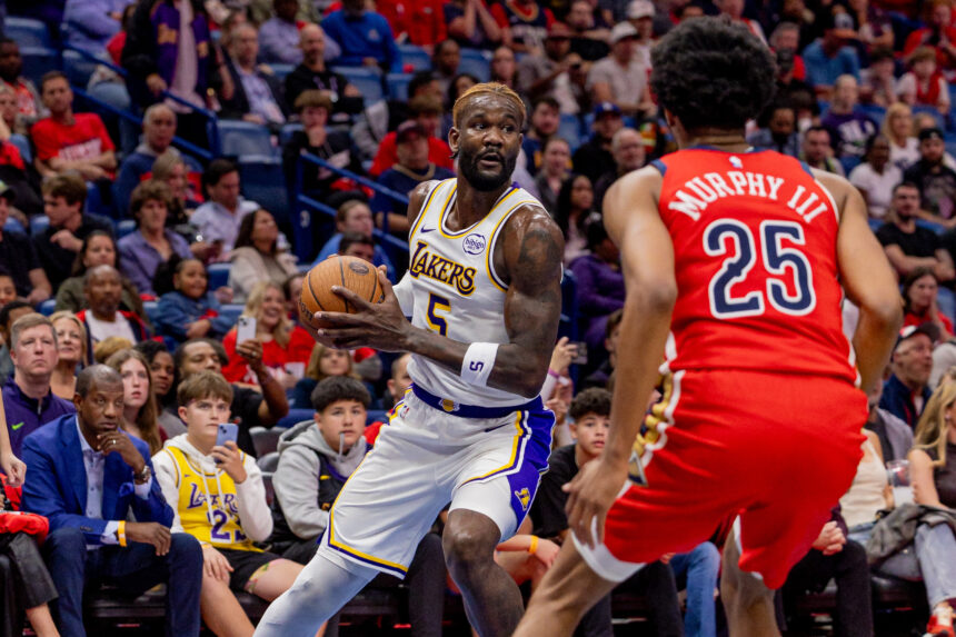 Nov 14, 2025; New Orleans, Louisiana, USA; Los Angeles Lakers center Deandre Ayton (5) dribbles against New Orleans Pelicans forward Trey Murphy III (25) during the first half at Smoothie King Center. Mandatory Credit: Stephen Lew-Imagn Images