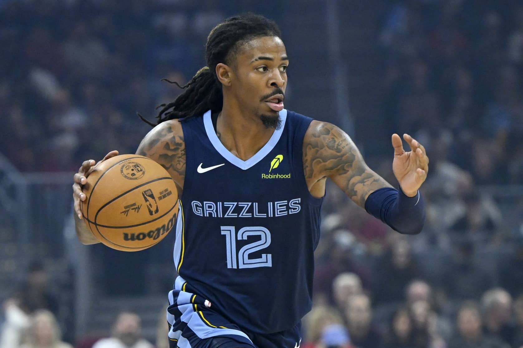 Nov 15, 2025; Cleveland, Ohio, USA; Memphis Grizzlies guard Ja Morant (12) dribbles the ball in the first quarter against the Cleveland Cavaliers at Rocket Arena. Mandatory Credit: David Richard-Imagn Images
