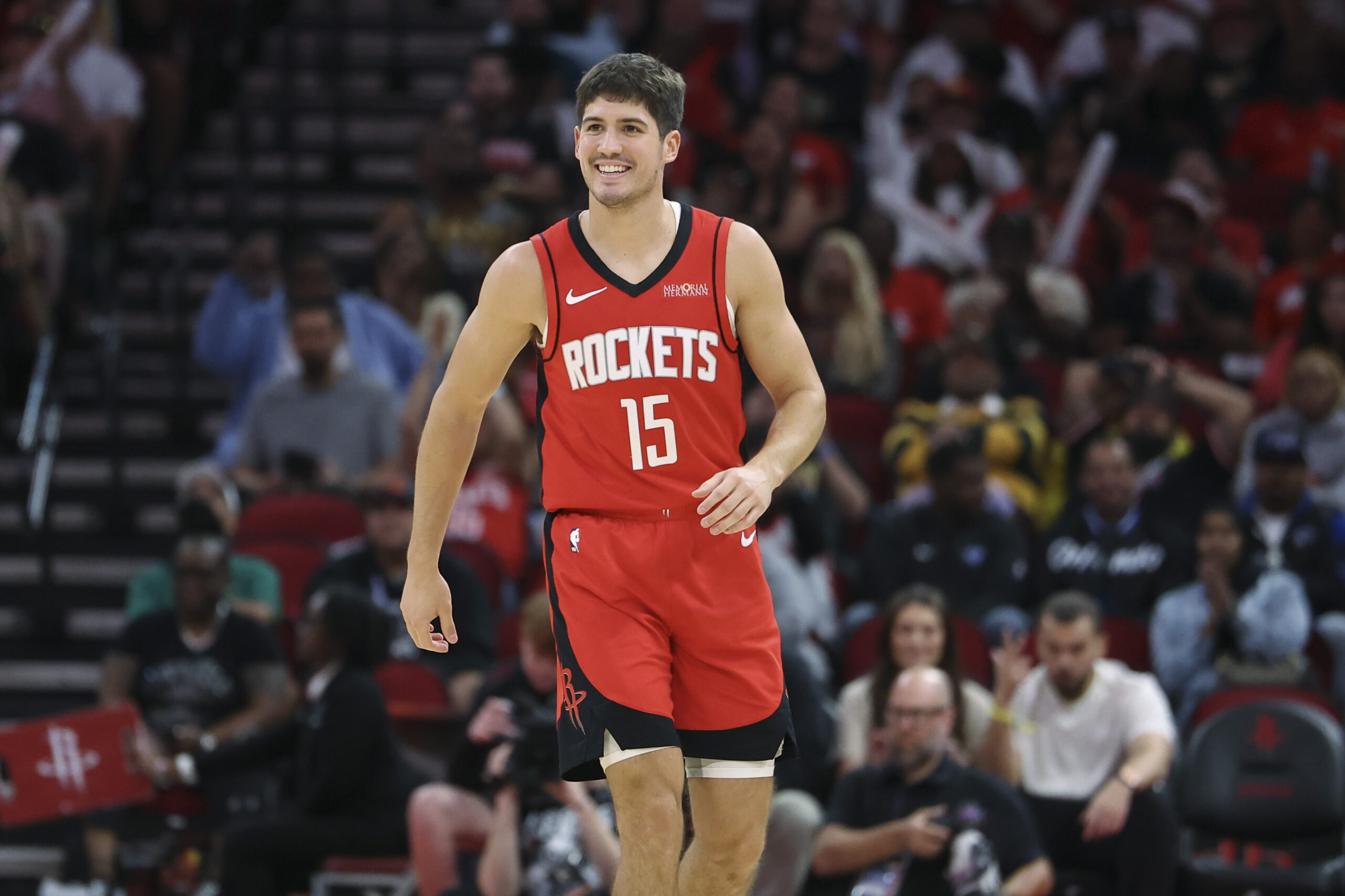 Nov 16, 2025; Houston, Texas, USA; Houston Rockets guard Reed Sheppard (15) smiles after a play during the second quarter against the Orlando Magic at Toyota Center. Mandatory Credit: Troy Taormina-Imagn Images