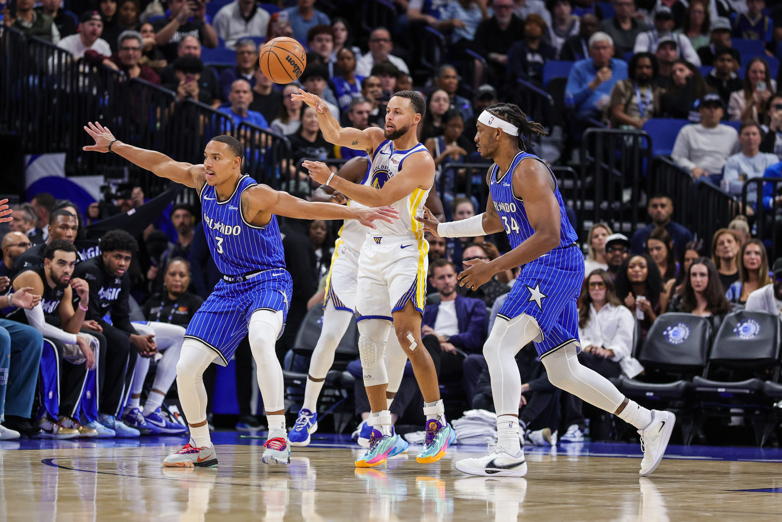 Nov 18, 2025; Orlando, Florida, USA; Golden State Warriors guard Stephen Curry (30) passes the ball over Orlando Magic guard Desmond Bane (3) during the first quarter at Kia Center. Mandatory Credit: Mike Watters-Imagn Images