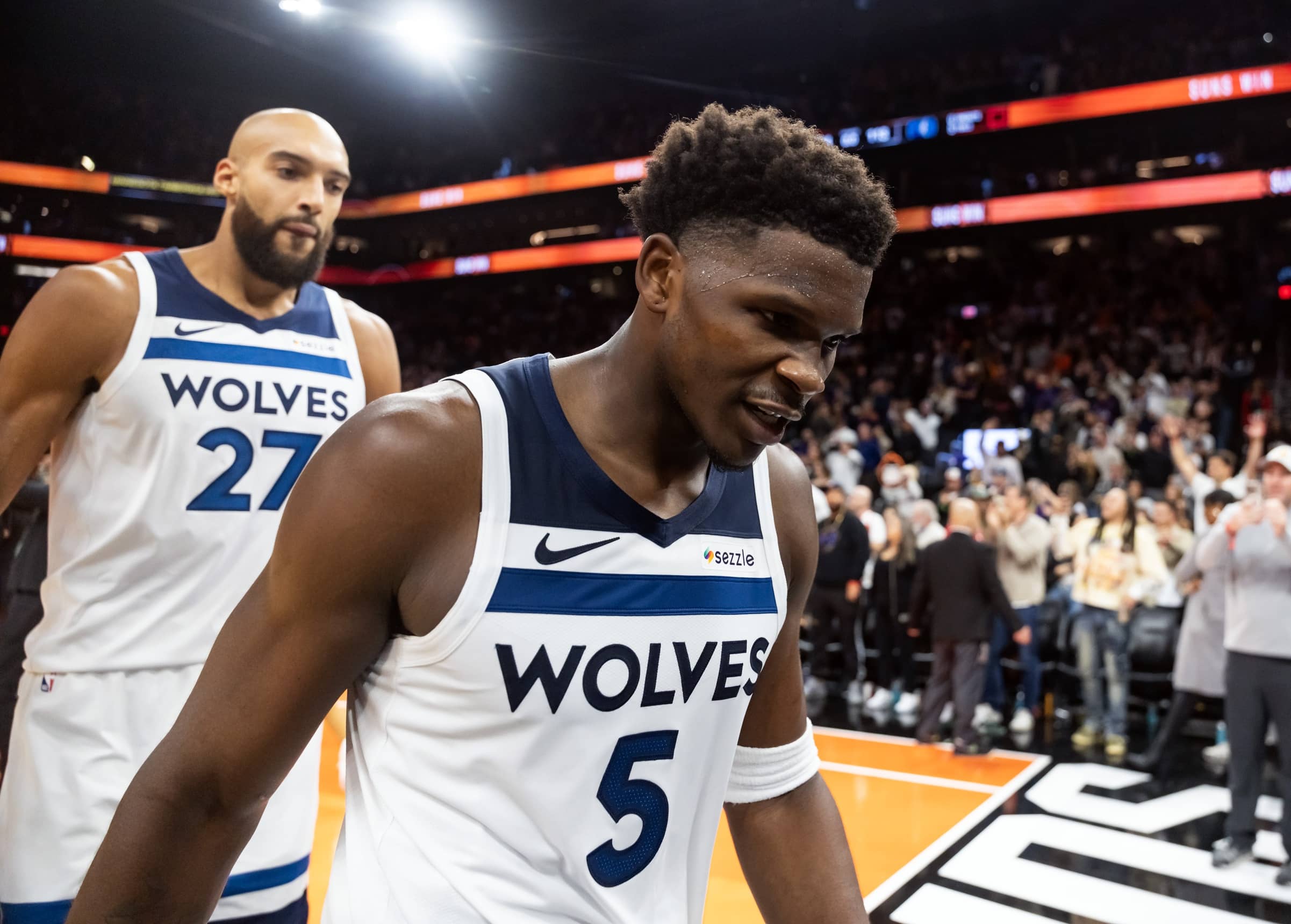 Nov 21, 2025; Phoenix, Arizona, USA; Minnesota Timberwolves guard Anthony Edwards (5) and center Rudy Gobert (27) react as they walk off the court after losing to the Phoenix Suns in the second half of an NBA Cup game at Mortgage Matchup Center. Mandatory Credit: Mark J. Rebilas-Imagn Images