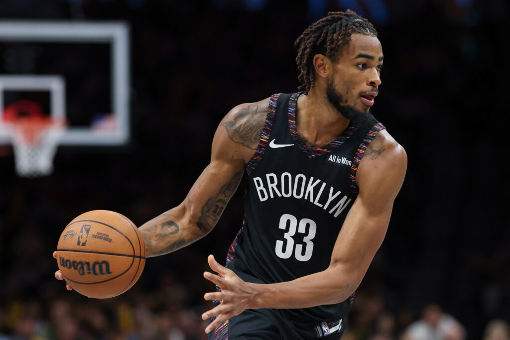 Nov 24, 2025; Brooklyn, New York, USA; Brooklyn Nets center Nic Claxton (33) dribbles during the second half against the New York Knicks at Barclays Center. Mandatory Credit: Vincent Carchietta-Imagn Images
