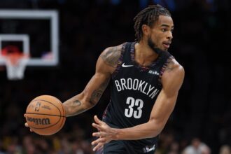 Nov 24, 2025; Brooklyn, New York, USA; Brooklyn Nets center Nic Claxton (33) dribbles during the second half against the New York Knicks at Barclays Center. Mandatory Credit: Vincent Carchietta-Imagn Images
