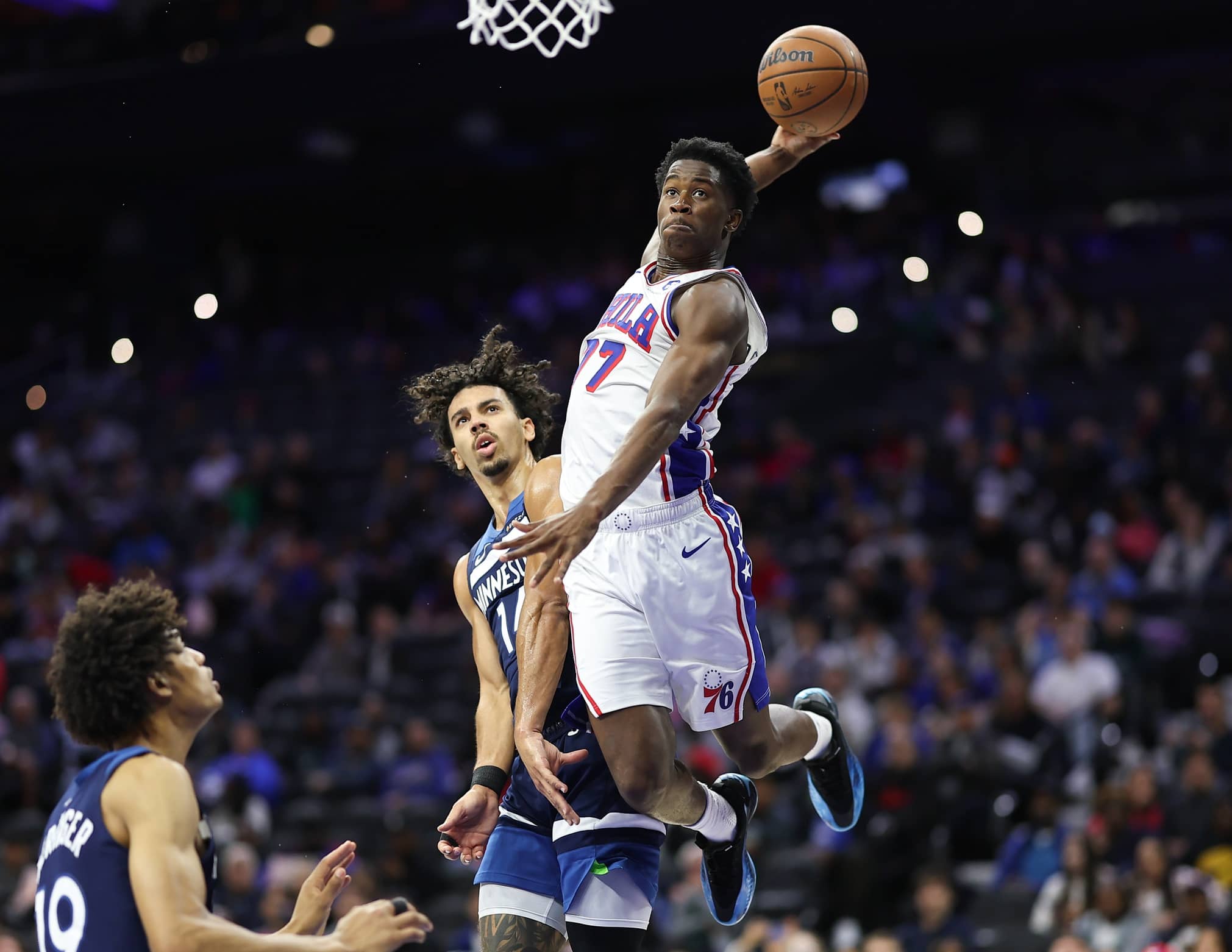 Oct 17, 2025; Philadelphia, Pennsylvania, USA; Philadelphia 76ers guard Vj Edgecombe (77) is fouled by Minnesota Timberwolves guard Jules Bernard (14) while driving for a dunk during the fourth quarter at Xfinity Mobile Arena. Mandatory Credit: Bill Streicher-Imagn Images