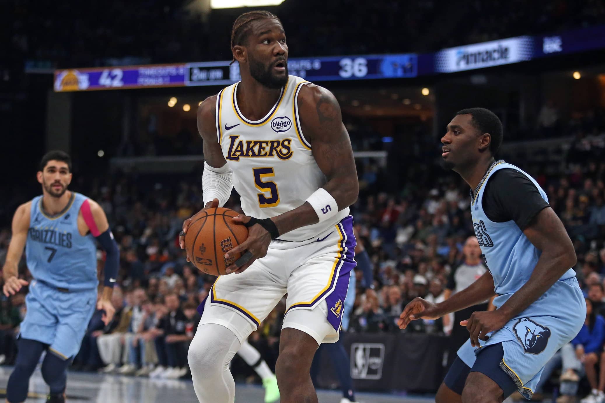 Memphis, Tennessee, USA; Los Angeles Lakers center Deandre Ayton (5) spins to the basket as Memphis Grizzlies forward Vince Williams Jr. (5) defends during the second quarter at FedExForum. Mandatory Credit: Petre Thomas-Imagn Images