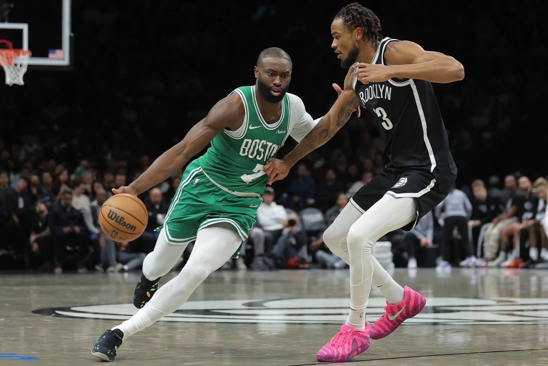Brooklyn, New York, USA; Boston Celtics guard Jaylen Brown (7) brings the ball up court against Brooklyn Nets center Nic Claxton (33) during the second quarter at Barclays Center. Mandatory Credit: Brad Penner-Imagn Images