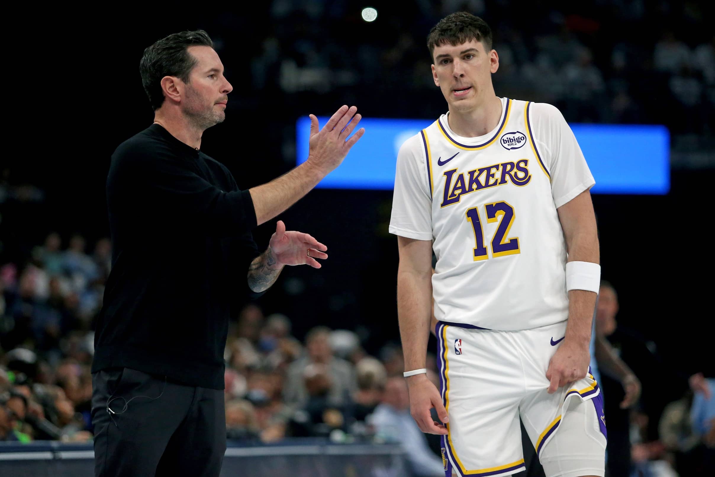 Memphis, Tennessee, USA; Los Angeles Lakers head coach JJ Redick talks with forward Jake LaRavia (12) during the first quarter against the Memphis Grizzlies at FedExForum. Mandatory Credit: Petre Thomas-Imagn Images