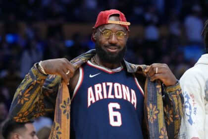 Los Angeles, California, USA; Los Angeles Lakers forward LeBron James poses in the Arizona Wildcats jersey of his son Bryce James (6) during the game against the Minnesota Timberwolves at Crypto.com Arena. Mandatory Credit: Kirby Lee-Imagn Images