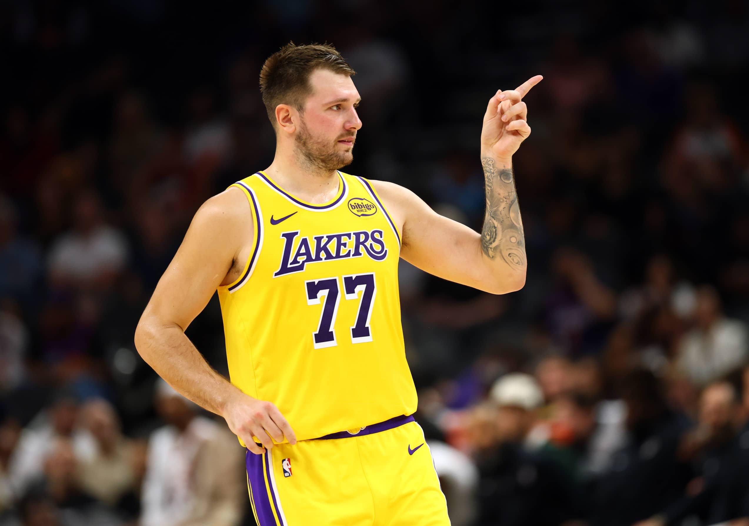 Phoenix, Arizona, USA; Los Angeles Lakers guard Luka Doncic (77) reacts against the Phoenix Suns during an NBA preseason game at Mortgage Matchup Center. Mandatory Credit: Mark J. Rebilas-Imagn Images