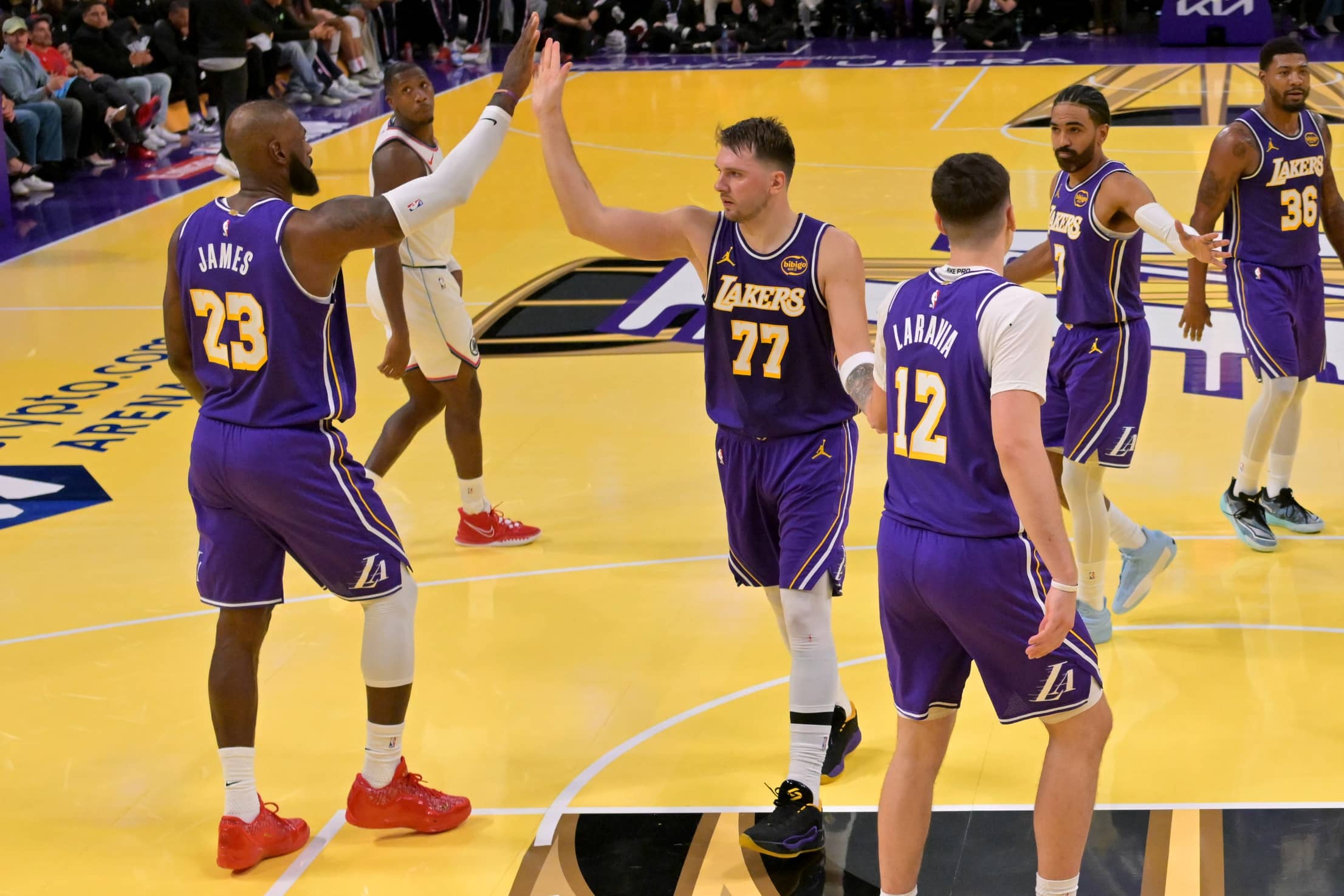 Los Angeles, California, USA; Los Angeles Lakers forward LeBron James (23) and guard Luka Doncic (77) high five during a time out in the second half against the Los Angeles Clippers at Crypto.com Arena. Mandatory Credit: Jayne Kamin-Oncea-Imagn Images