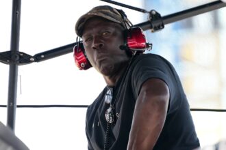 Homestead, Florida, USA; 23XI Team co-owner Michael Jordan sits atop of the pitbox during the 4EVER 400 presented by Mobil 1 at Homestead-Miami Speedway. Mandatory Credit: Jasen Vinlove-Imagn Images
