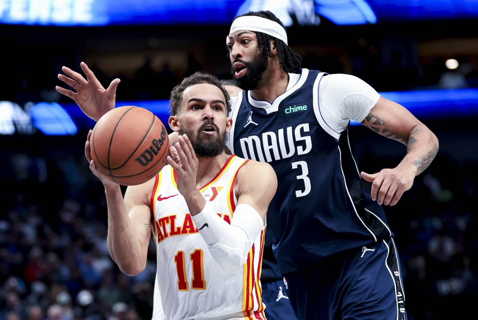 Atlanta Hawks guard Trae Young (11) looks to pass as Dallas Mavericks forward Anthony Davis (3) defends during the fourth quarter at American Airlines Center.