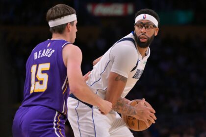 Los Angeles Lakers guard Austin Reaves (15) defends Dallas Mavericks forward Anthony Davis (3) in the second half at Crypto.com Arena.