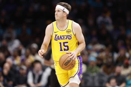 Charlotte, North Carolina, USA; Los Angeles Lakers guard Austin Reaves (15) brings the ball up the court during the second quarter against the Charlotte Hornets at Spectrum Center. Mandatory Credit: Brian Westerholt-Imagn Images