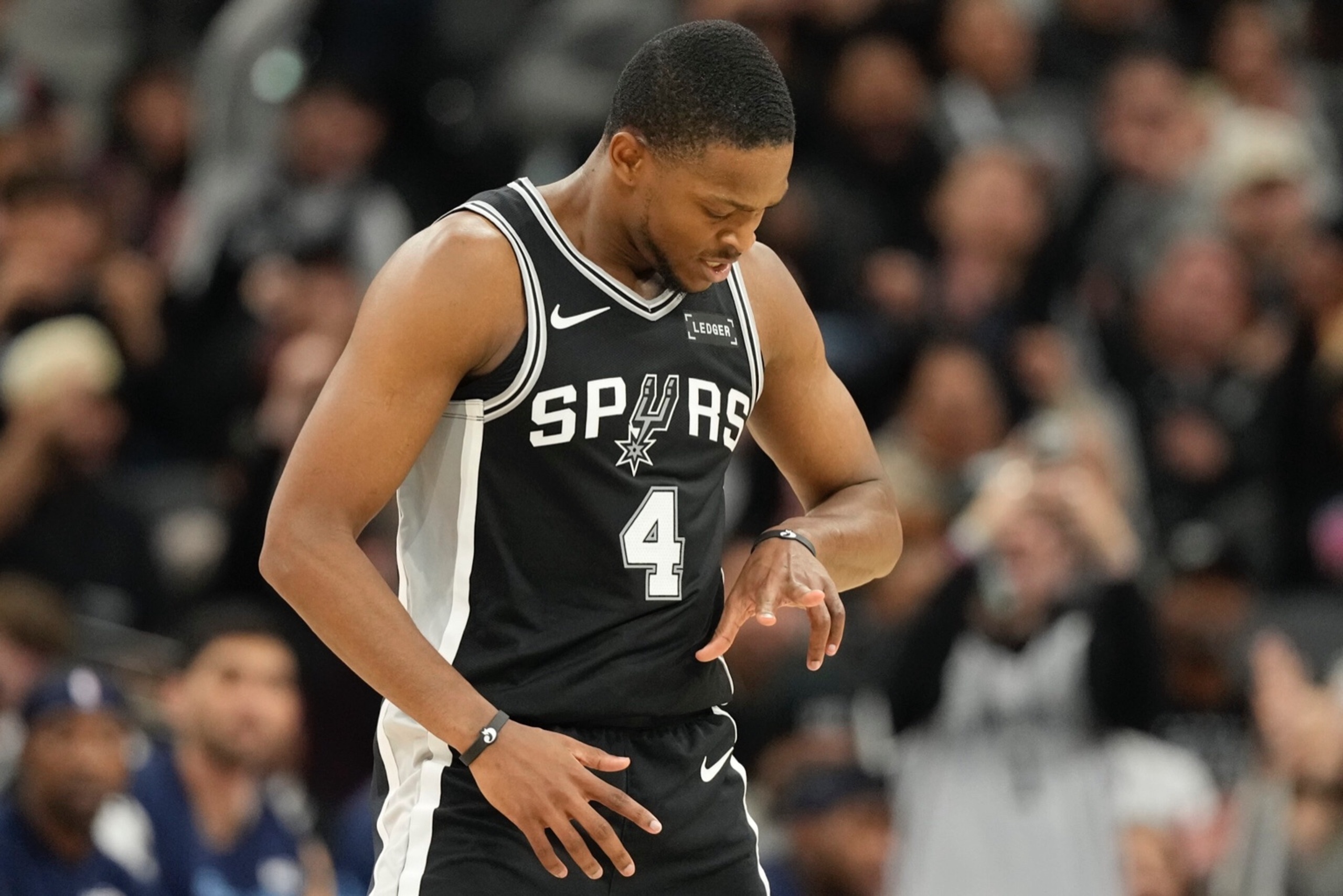 Dec 2, 2025; San Antonio, Texas, USA; San Antonio Spurs guard De’Aaron Fox (4) reacts after scoring a three point basket during the second half against the Memphis Grizzlies at Frost Bank Center. Mandatory Credit: Scott Wachter-Imagn Images