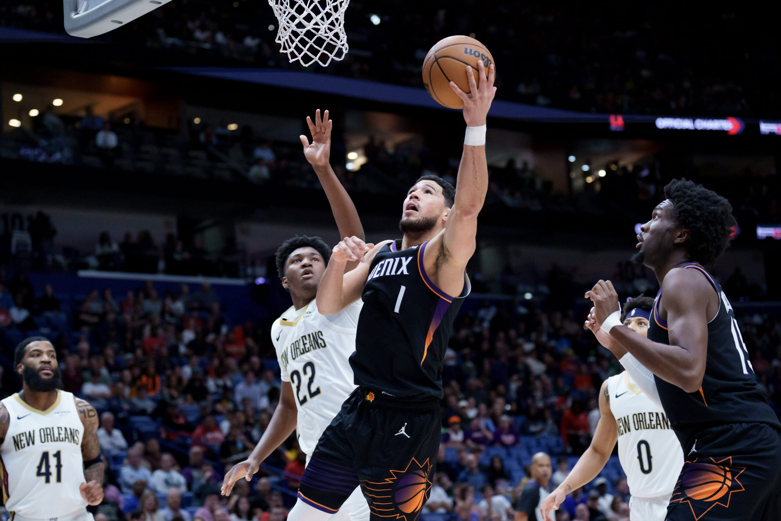 Dec 26, 2025; New Orleans, Louisiana, USA; Phoenix Suns guard Devin Booker (1) shoot against New Orleans Pelicans center Derik Queen (22) at Smoothie King Center. Mandatory Credit: Matthew Hinton-Imagn Images