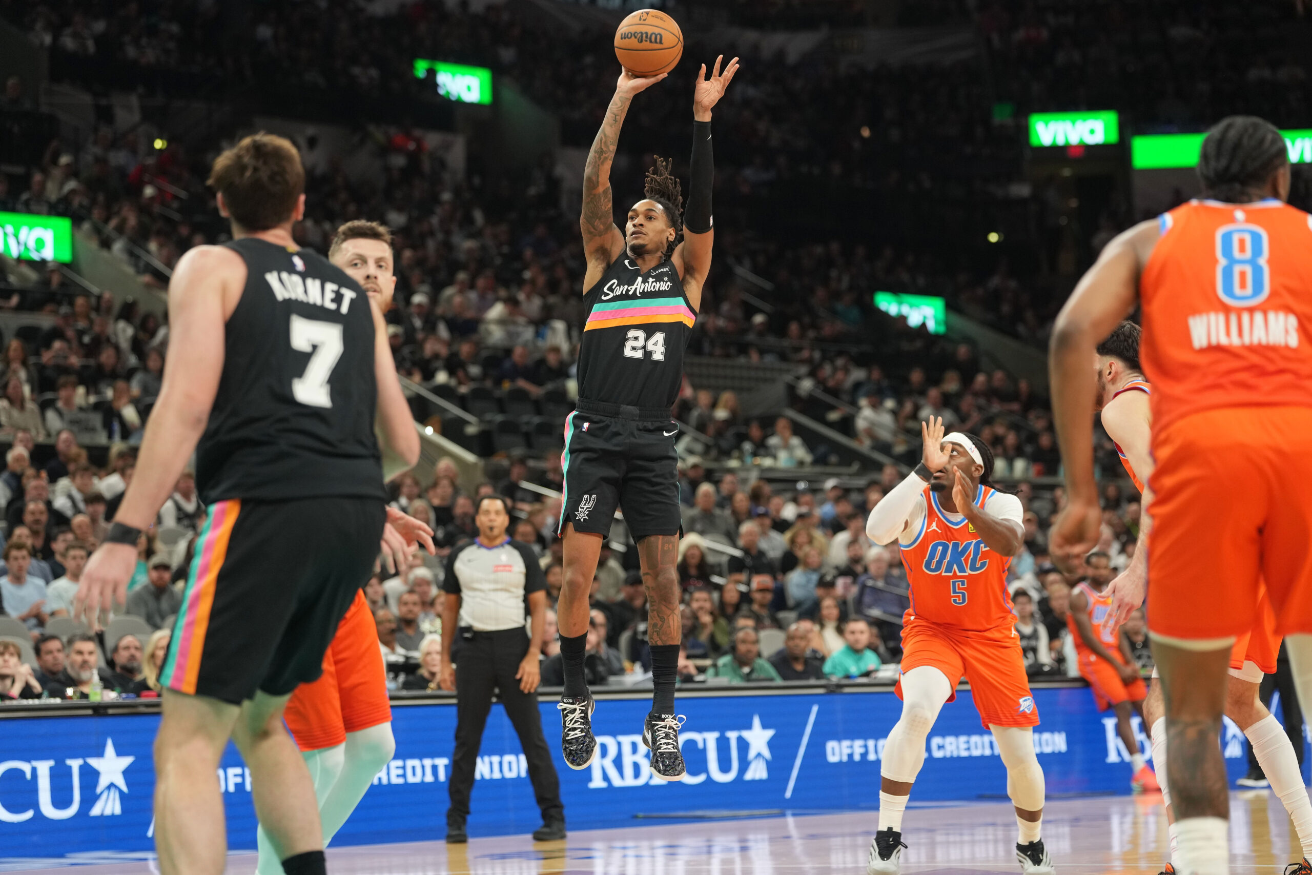 Dec 23, 2025; San Antonio, Texas, USA; San Antonio Spurs guard Devin Vassell (24) shoots during the first half against the Oklahoma City Thunder at Frost Bank Center. Mandatory Credit: Scott Wachter-Imagn Images