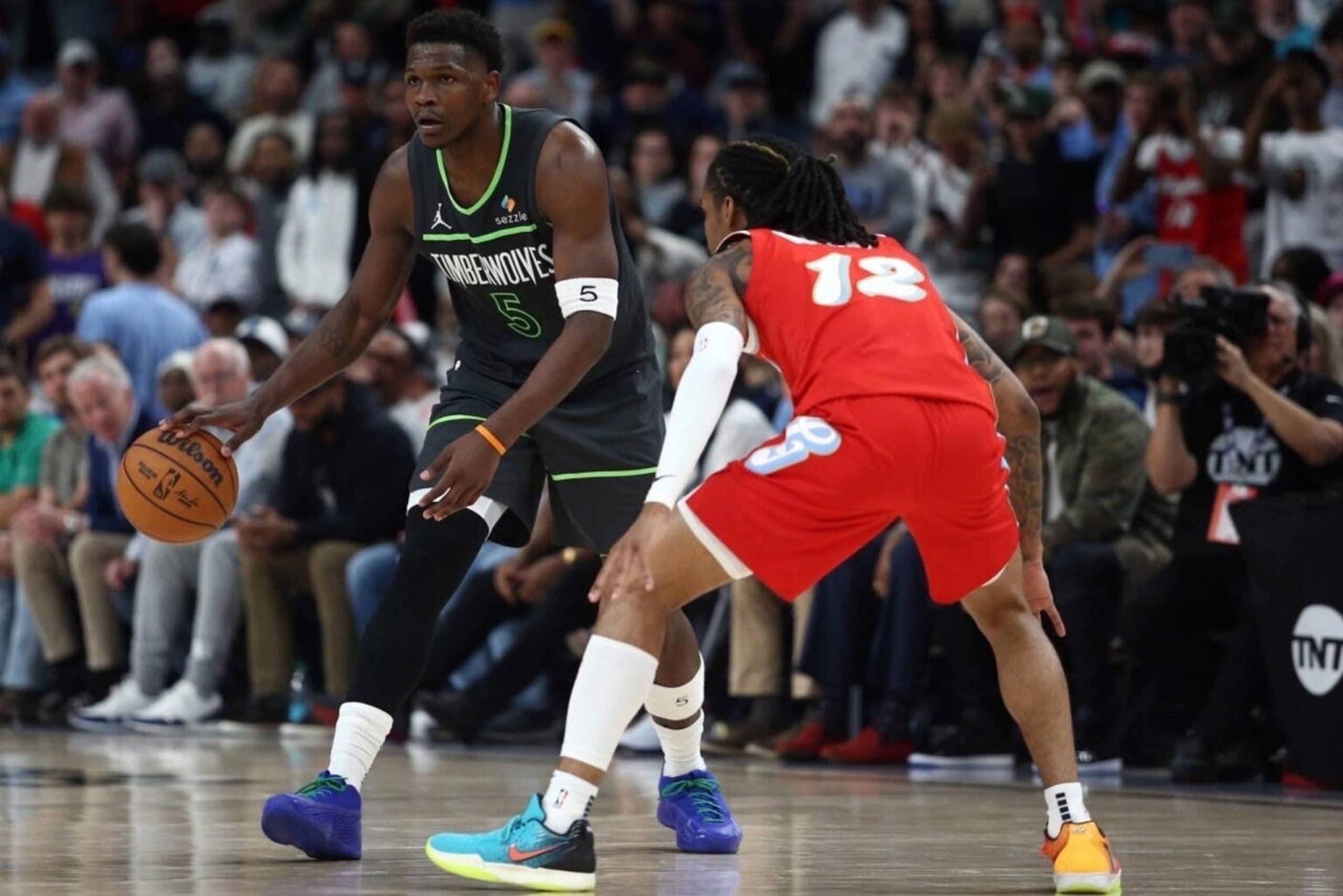 Apr 10, 2025; Memphis, Tennessee, USA; Minnesota Timberwolves guard Anthony Edwards (5) dribbles as Memphis Grizzlies guard Ja Morant (12) defends during the fourth quarter at FedExForum. Mandatory Credit: Petre Thomas-Imagn Images