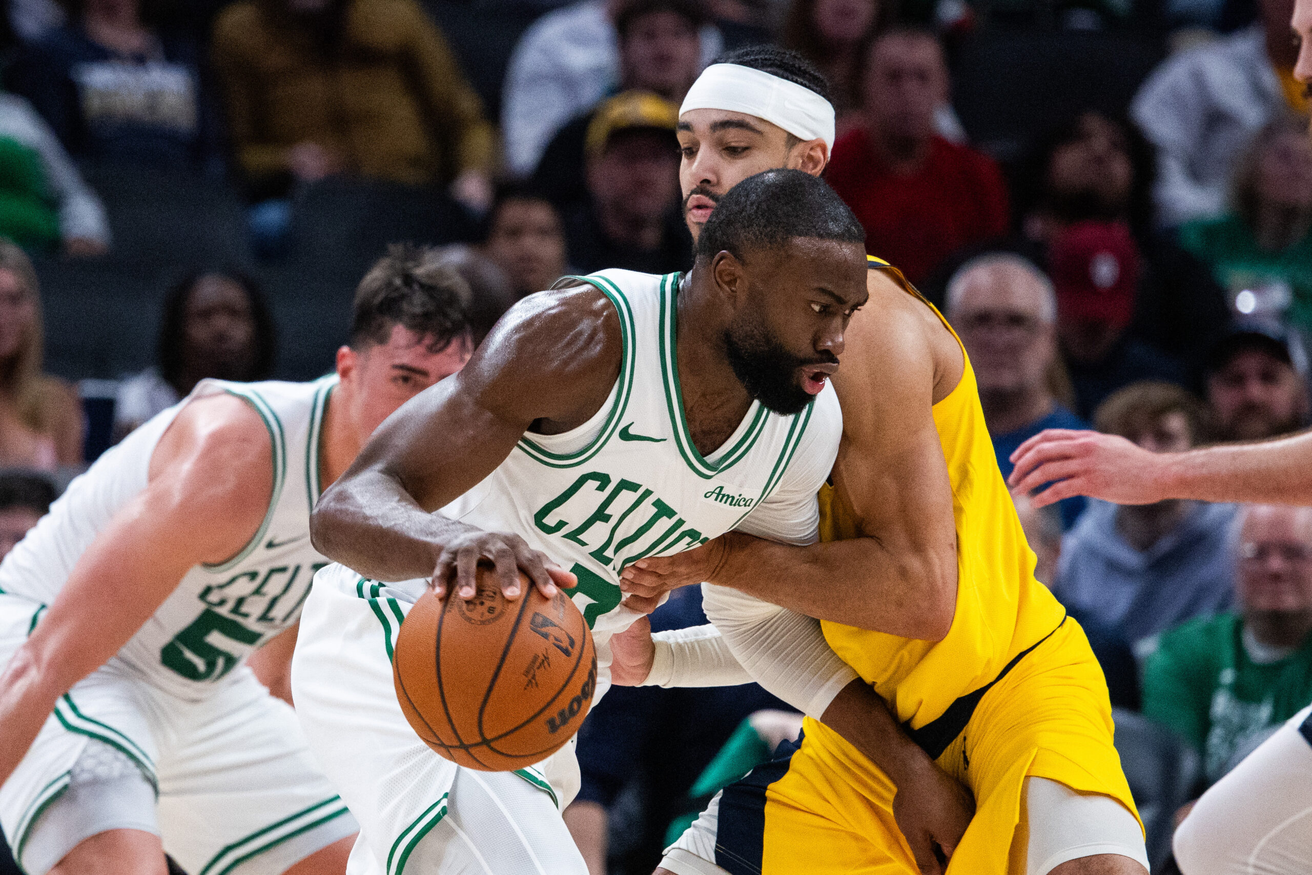 Dec 26, 2025; Indianapolis, Indiana, USA; Boston Celtics guard/forward Jaylen Brown (7) dribbles the ball while Indiana Pacers guard/forward Andrew Nembhard (2) defends in the first half at Gainbridge Fieldhouse. Mandatory Credit: Trevor Ruszkowski-Imagn Images
