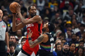 Houston Rockets forward Kevin Durant (7) holds the ball as he is defended by Denver Nuggets guard Bruce Brown (11) during the second half at Ball Arena.