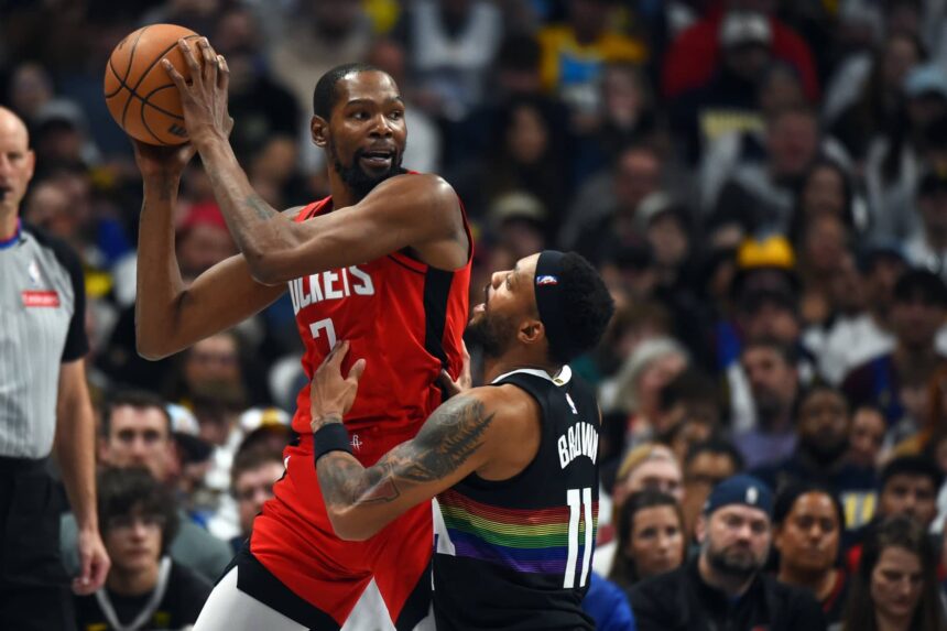 Houston Rockets forward Kevin Durant (7) holds the ball as he is defended by Denver Nuggets guard Bruce Brown (11) during the second half at Ball Arena.