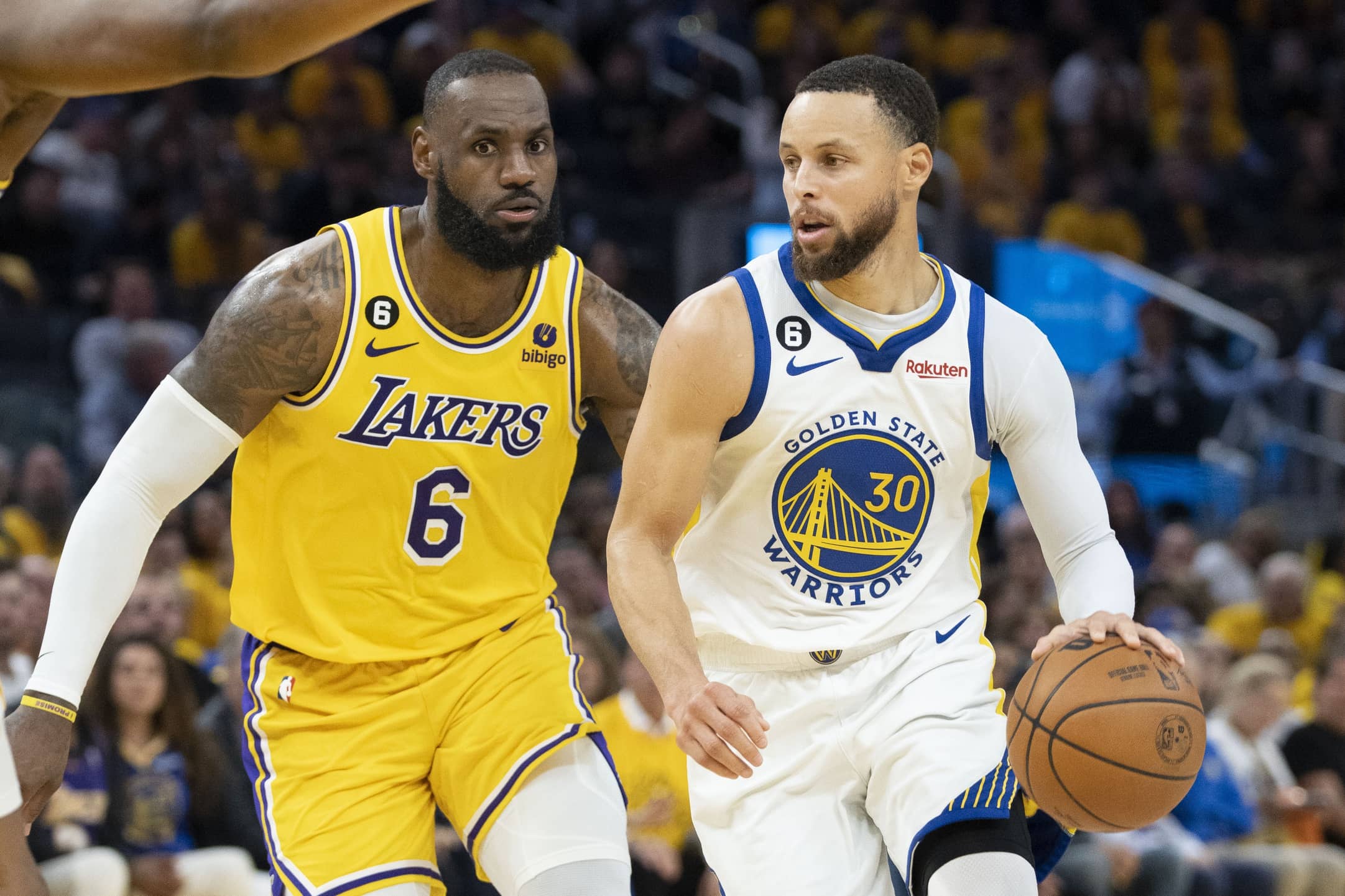 Golden State Warriors guard Stephen Curry (30) dribbles the basketball against Los Angeles Lakers forward LeBron James (6) during the fourth quarter in game five of the 2023 NBA playoffs conference semifinals round at Chase Center.