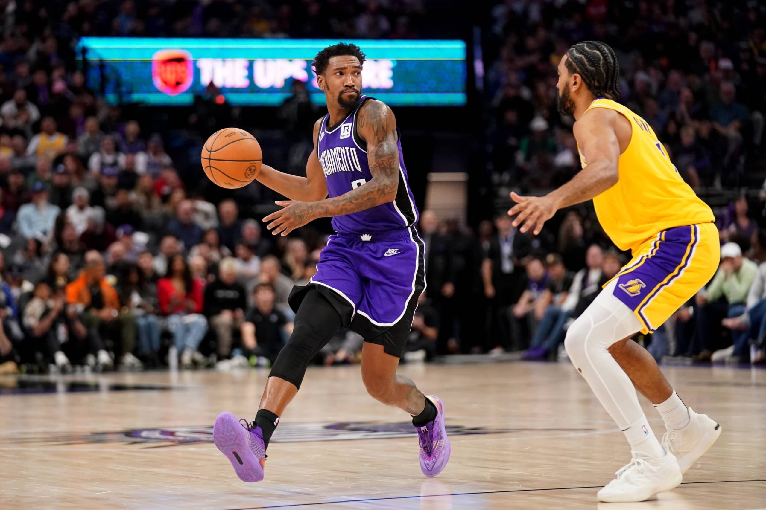 Dec 19, 2024; Sacramento, California, USA; Sacramento Kings guard Malik Monk (0) dribbles the ball next to Los Angeles Lakers guard Gabe Vincent (7) in the third quarter at the Golden 1 Center. Mandatory Credit: Cary Edmondson-Imagn Images
