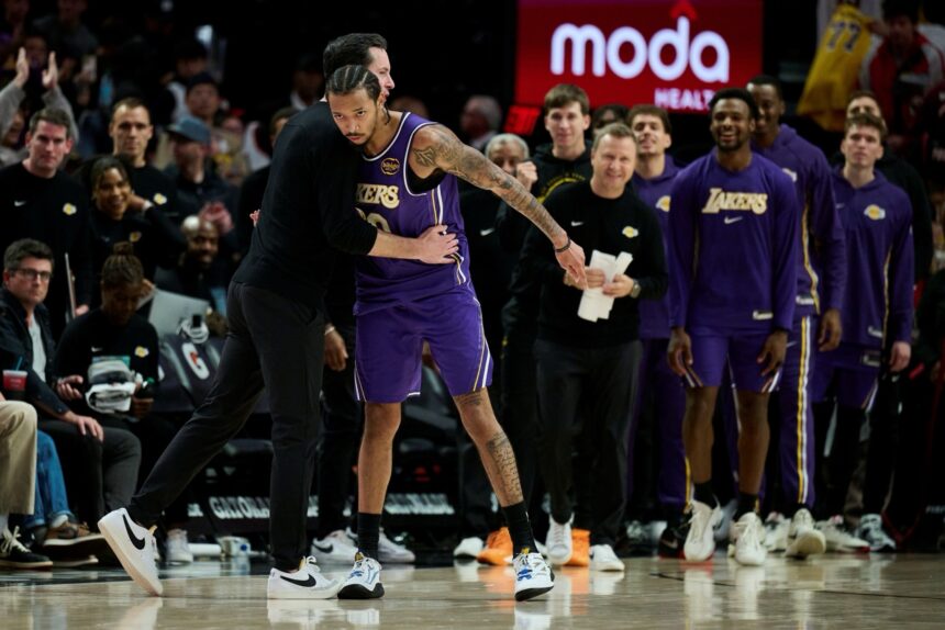Nov 3, 2025; Portland, Oregon, USA; Los Angeles Lakers guard Nick Smith Jr. (20) celebrates with head coach JJ Redick after a game against the Portland Trail Blazers at Moda Center. Mandatory Credit: Troy Wayrynen-Imagn Images