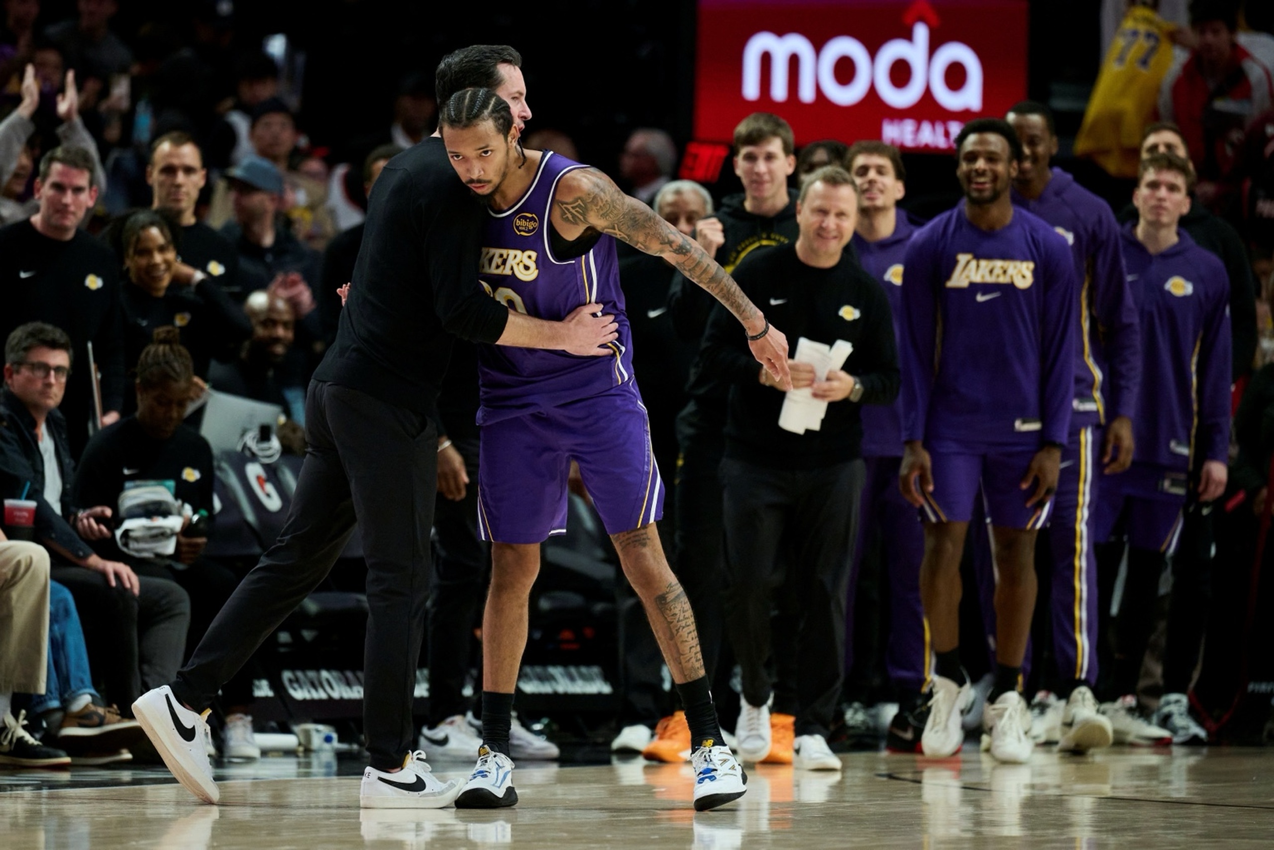 Nov 3, 2025; Portland, Oregon, USA; Los Angeles Lakers guard Nick Smith Jr. (20) celebrates with head coach JJ Redick after a game against the Portland Trail Blazers at Moda Center. Mandatory Credit: Troy Wayrynen-Imagn Images