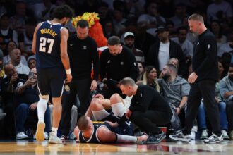 Dec 29, 2025; Miami, Florida, USA; Denver Nuggets center Nikola Jokic (15) is looked at by trainers after an injury against the Miami Heat during the second quarter at Kaseya Center. Mandatory Credit: Sam Navarro-Imagn Images