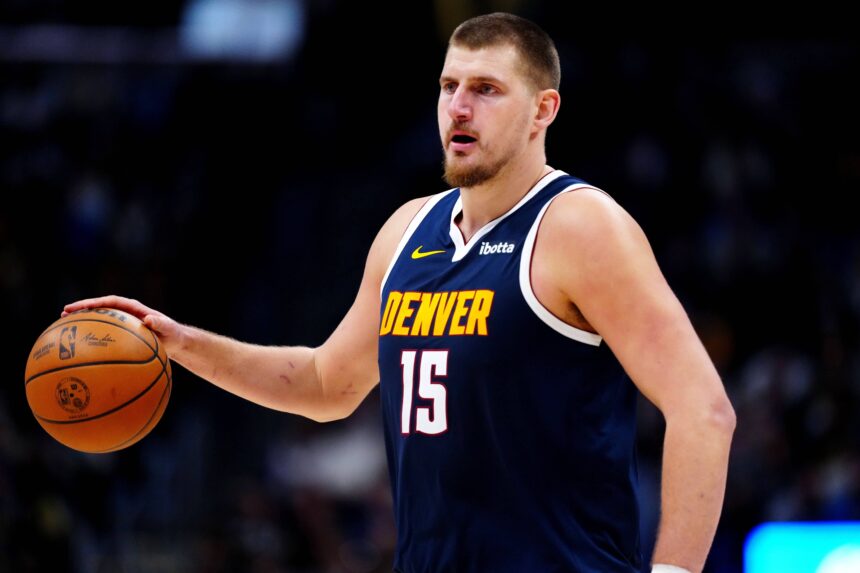 Denver Nuggets center Nikola Jokic (15) controls the ball in the fourth quarter against the Houston Rockets at Ball Arena.