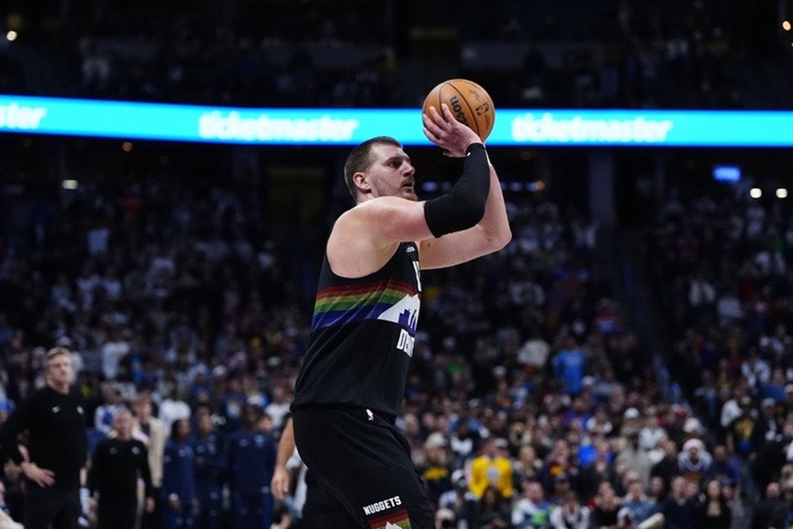 Dec 25, 2025; Denver, Colorado, USA; Denver Nuggets center Nikola Jokic (15) lines up a successful three point basket in overtime against the Minnesota Timberwolves at Ball Arena. Mandatory Credit: Ron Chenoy-Imagn Images