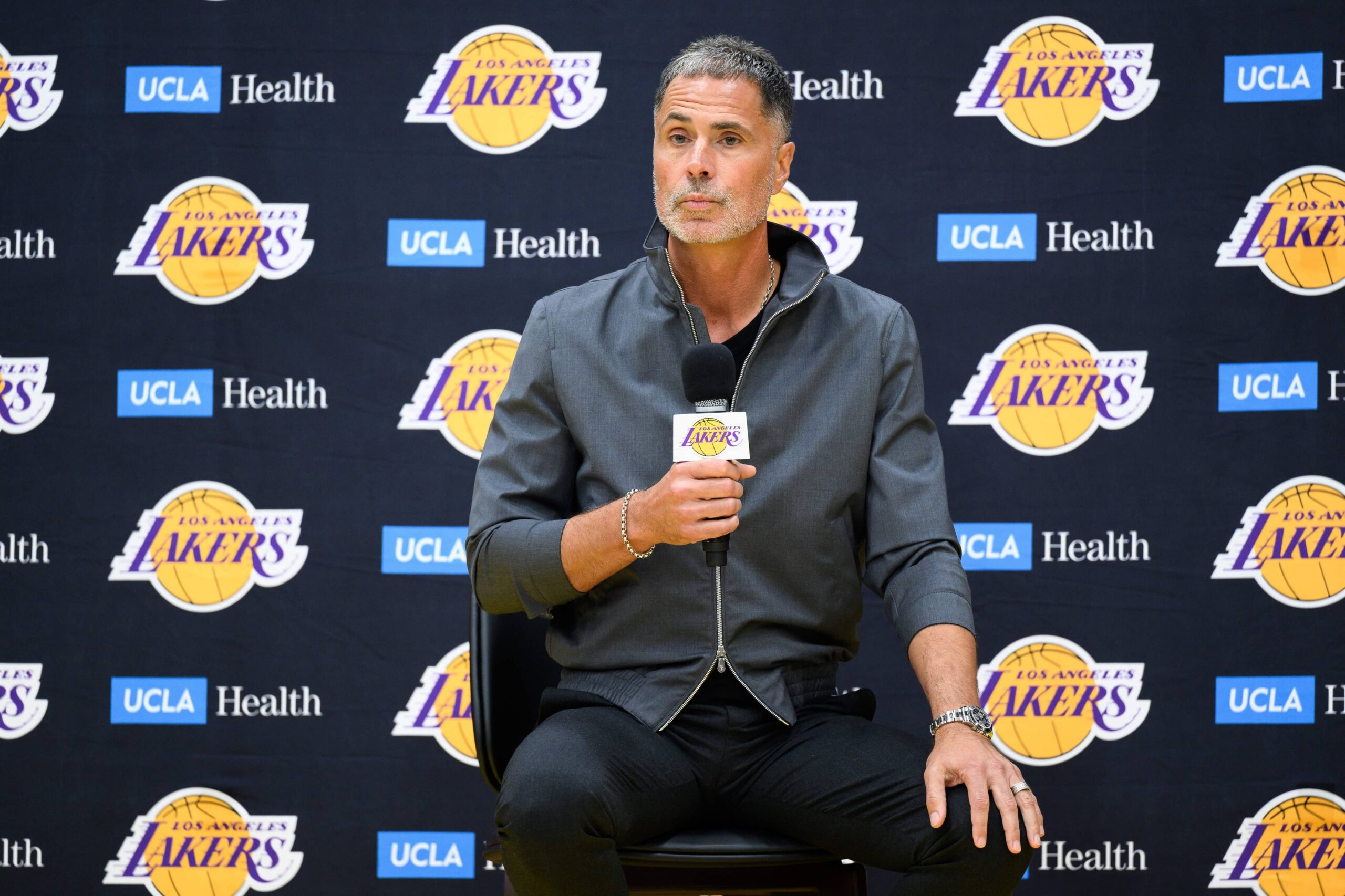 Los Angeles Lakers general manager Rob Pelinka, left, speaks during a press conference to preview the 2025-26 season at UCLA Health Training Center.