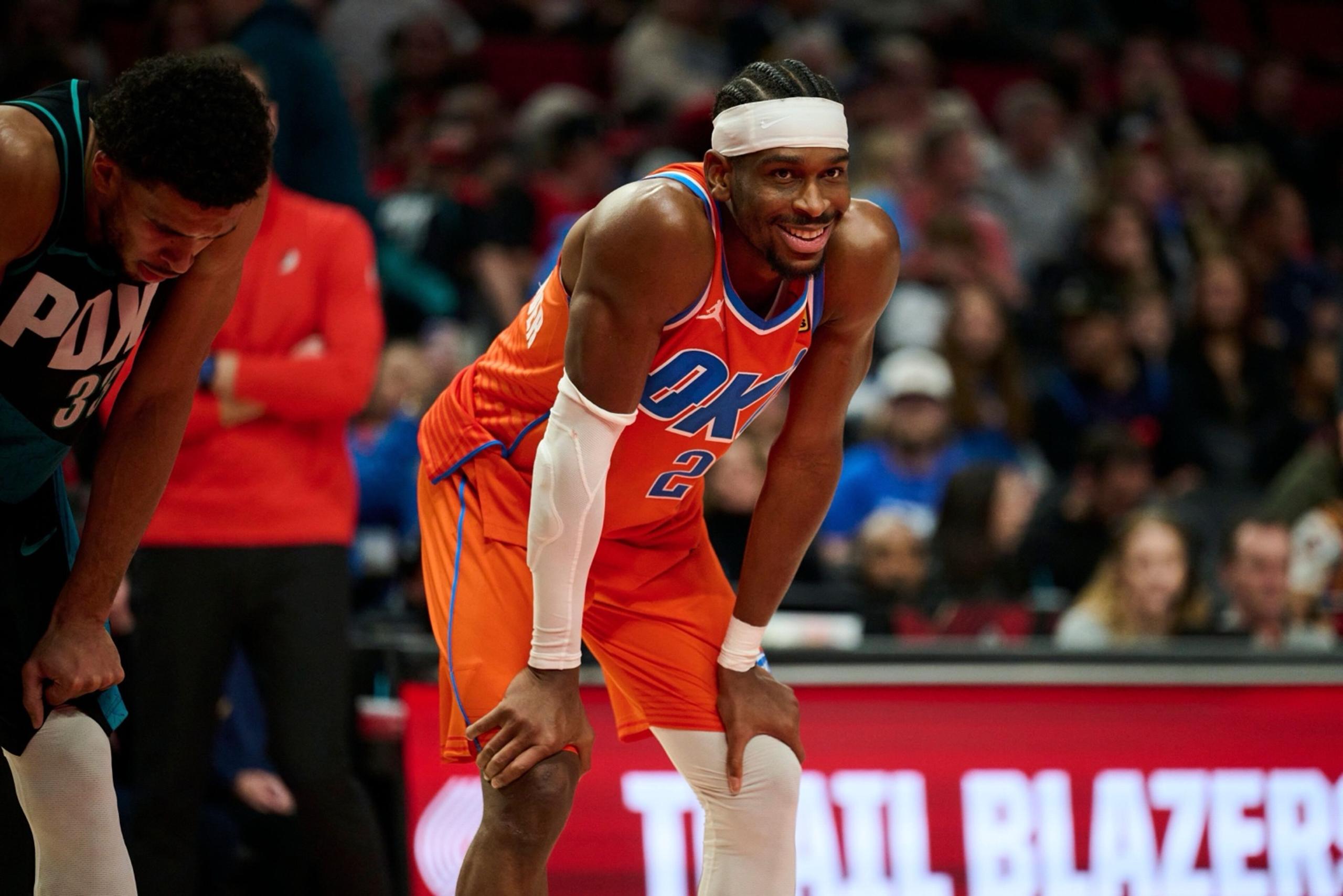 Nov 30, 2025; Portland, Oregon, USA; Oklahoma City Thunder guard Shai Gilgeous-Alexander (2) smiles at a fan during the second half in a game against the Portland Trail Blazers at Moda Center. Mandatory Credit: Troy Wayrynen-Imagn Images