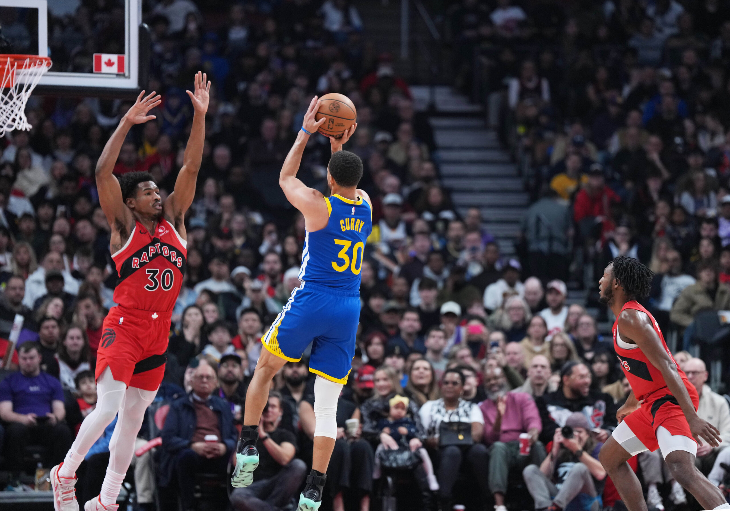 Dec 28, 2025; Toronto, Ontario, CAN; Golden State Warriors guard Stephen Curry (30) shoots the ball as Toronto Raptors guard Ochai Agbaji (30) tries to defend during the first quarter at Scotiabank Arena. Mandatory Credit: Nick Turchiaro-Imagn Images