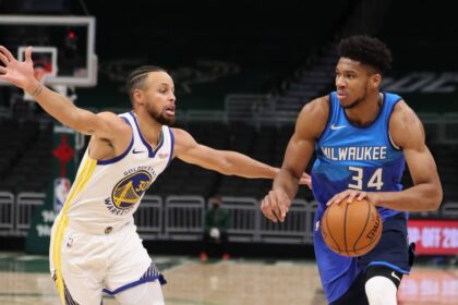 Dec 25, 2020; Milwaukee, WI, USA; Milwaukee Bucks forward Giannis Antetokounmpo (34) dribbles the ball against Golden State Warriors guard Stephen Curry (30) during a NBA game at the Bradley Center. Mandatory Credit: Nick Monroe/Handout Photo-Imagn Images