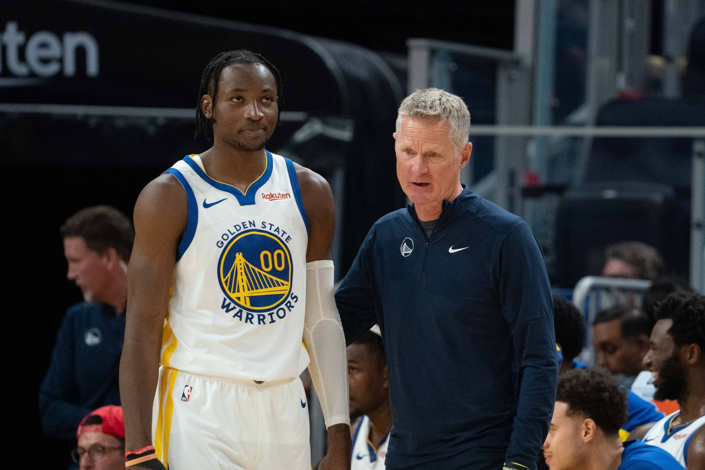 October 20, 2023; San Francisco, California, USA; Golden State Warriors head coach Steve Kerr (right) talks to forward Jonathan Kuminga (00) during the third quarter against the San Antonio Spurs at Chase Center. Mandatory Credit: Kyle Terada-Imagn Images
