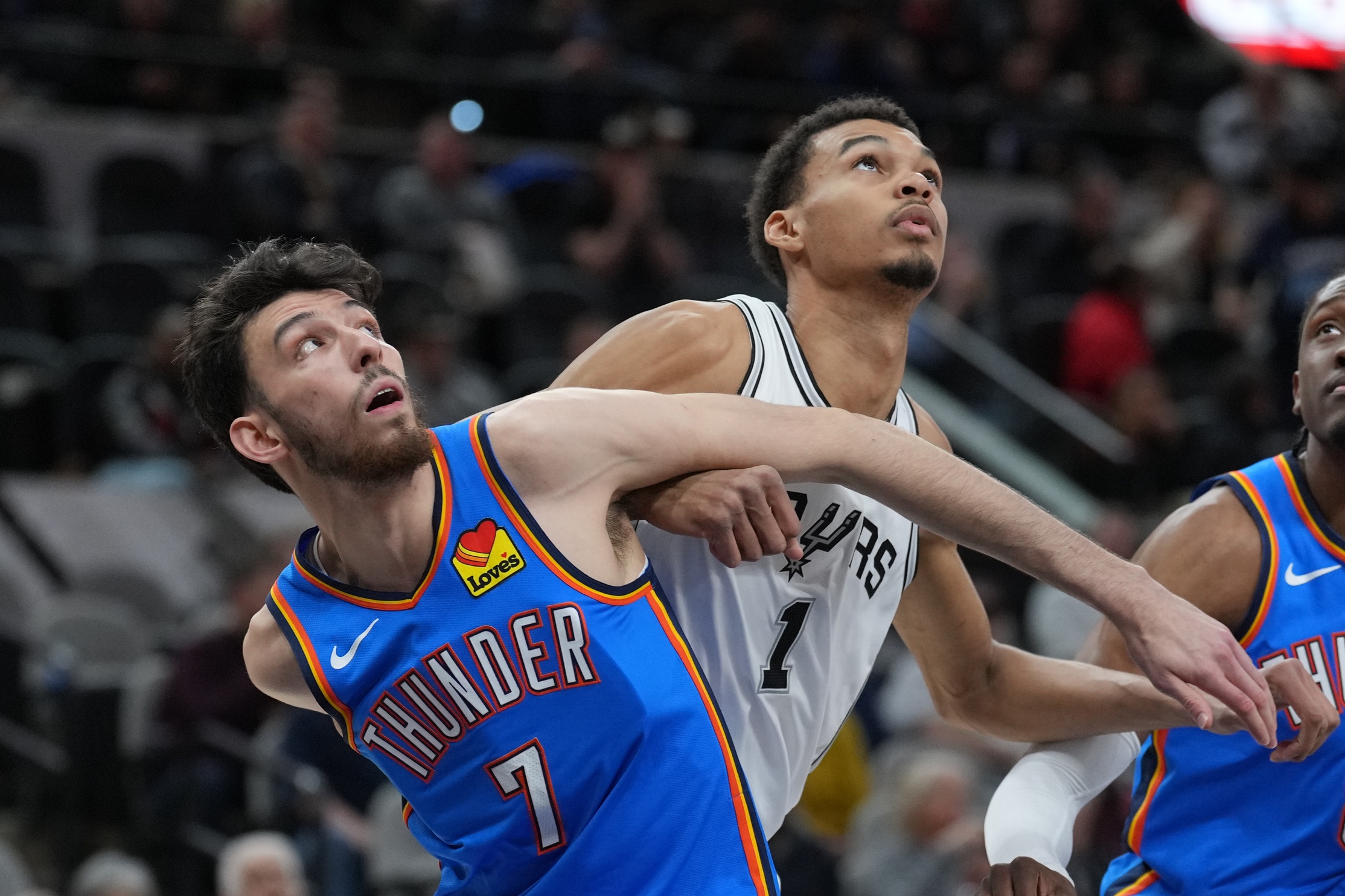 Feb 29, 2024; San Antonio, Texas, USA; Oklahoma City Thunder forward Chet Holmgren (7) and San Antonio Spurs center Victor Wembanyama (1) battle for position in the first half at Frost Bank Center. Mandatory Credit: Daniel Dunn-USA TODAY Sports
