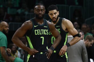 Boston, Massachusetts, USA; Boston Celtics guard Jaylen Brown (7) and forward Jayson Tatum (0) stand on the court during a timeout during the second half of their loss to the Cleveland Cavaliers at TD Garden. Mandatory Credit: Winslow Townson-Imagn Images