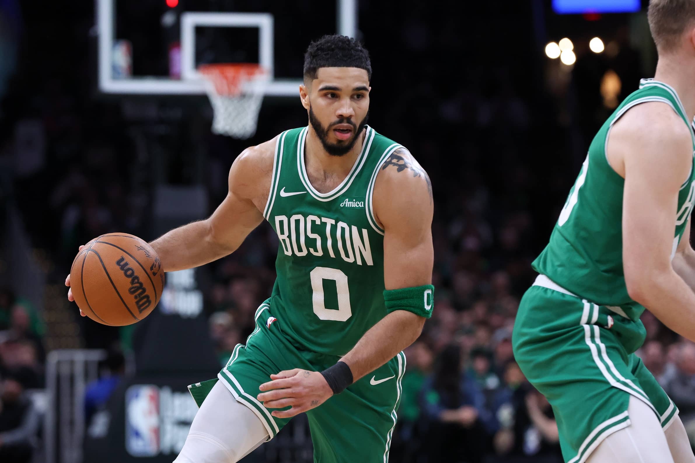 Mar 2, 2025; Boston, Massachusetts, USA; Boston Celtics forward Jayson Tatum (0) dribbles down the court during the second half against the Denver Nuggets at TD Garden. Mandatory Credit: Paul Rutherford-Imagn Images