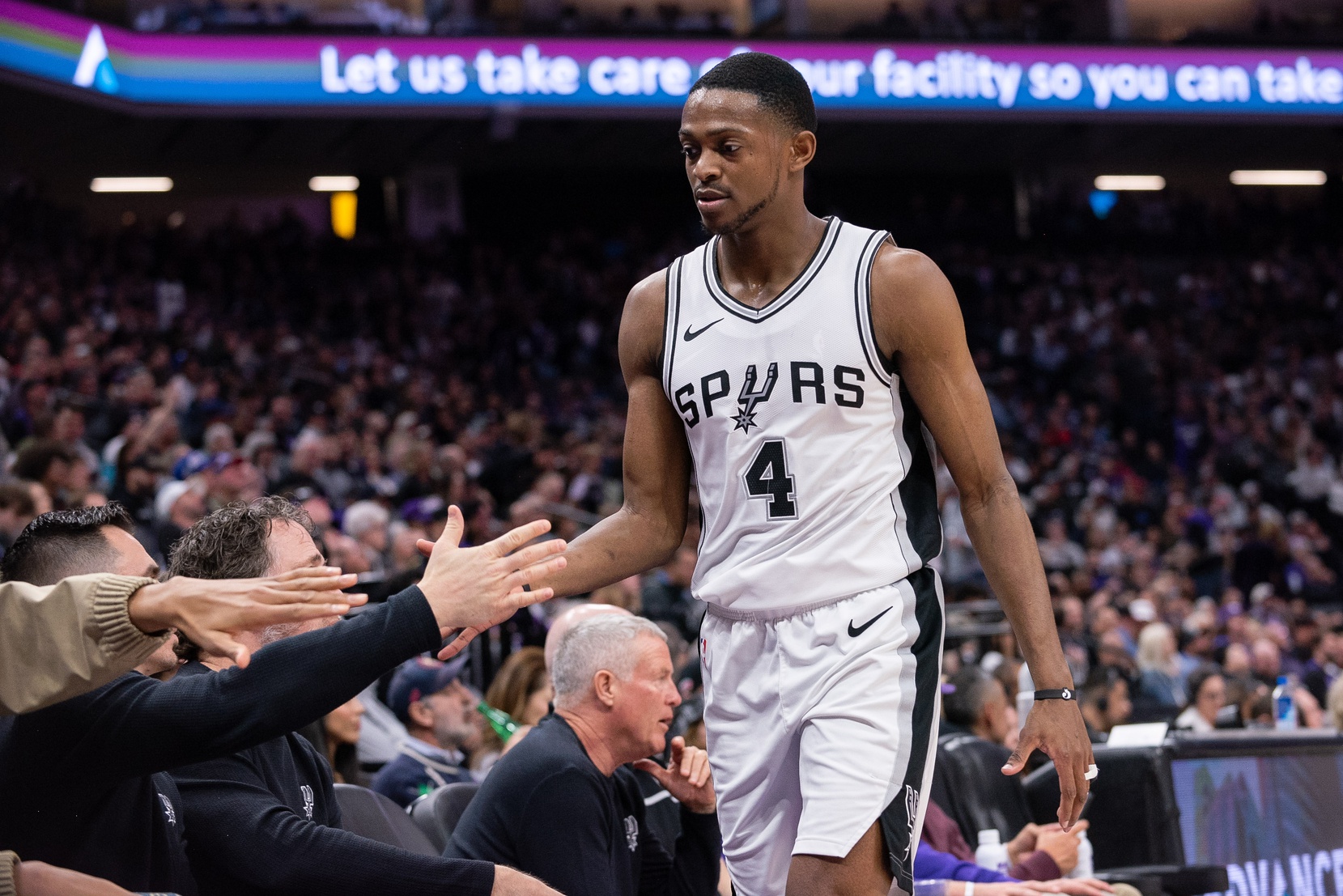 Mar 7, 2025; Sacramento, California, USA; San Antonio Spurs guard De'Aaron Fox (4) high fives team mates after coming out of the game during the fourth quarter at Golden 1 Center. Mandatory Credit: Ed Szczepanski-Imagn Images
