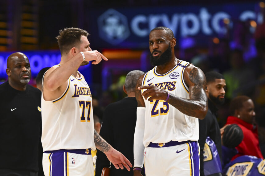 Mar 22, 2025; Los Angeles, California, USA; Los Angeles Lakers guard Luka Doncic (77) and Los Angeles Lakers forward LeBron James (23) on the sidelines against the Chicago Bulls during the first half at Crypto.com Arena. Mandatory Credit: Jonathan Hui-Imagn Images