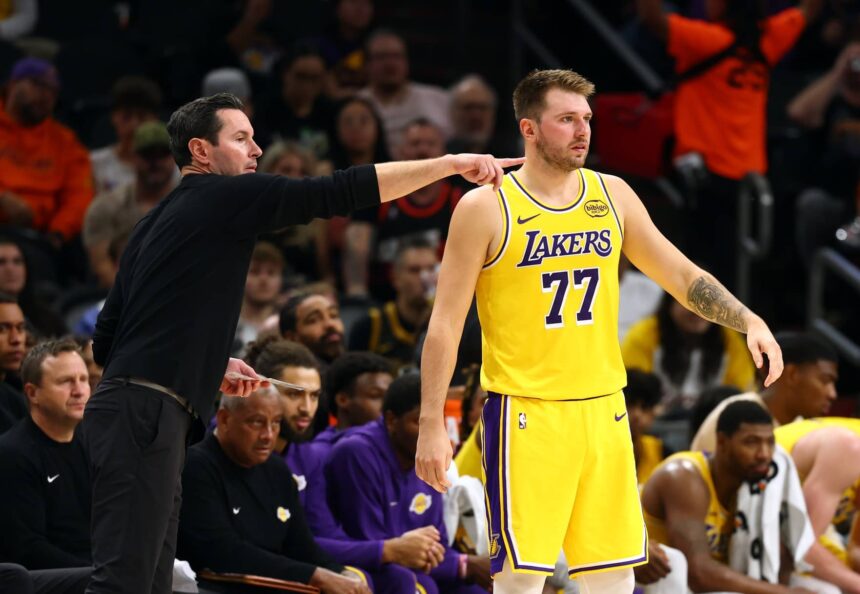 Oct 14, 2025; Phoenix, Arizona, USA; Los Angeles Lakers guard Luka Doncic (77) with head coach JJ Redick against the Phoenix Suns during an NBA preseason game at Mortgage Matchup Center. Mandatory Credit: Mark J. Rebilas-Imagn Images