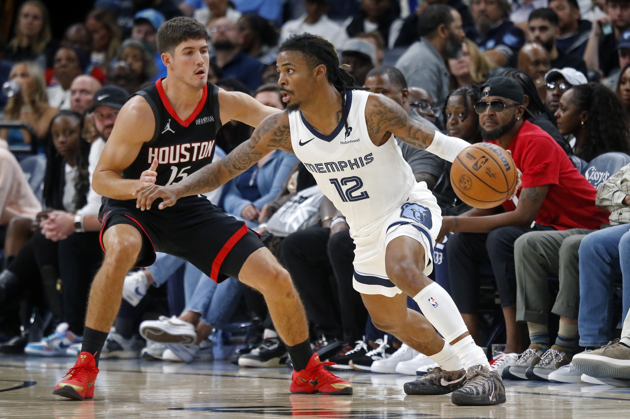 Nov 5, 2025; Memphis, Tennessee, USA; Memphis Grizzlies guard Ja Morant (12) dribbles as Houston Rockets guard Reed Sheppard (15) defends during the fourth quarter at FedExForum. Mandatory Credit: Petre Thomas-Imagn Images