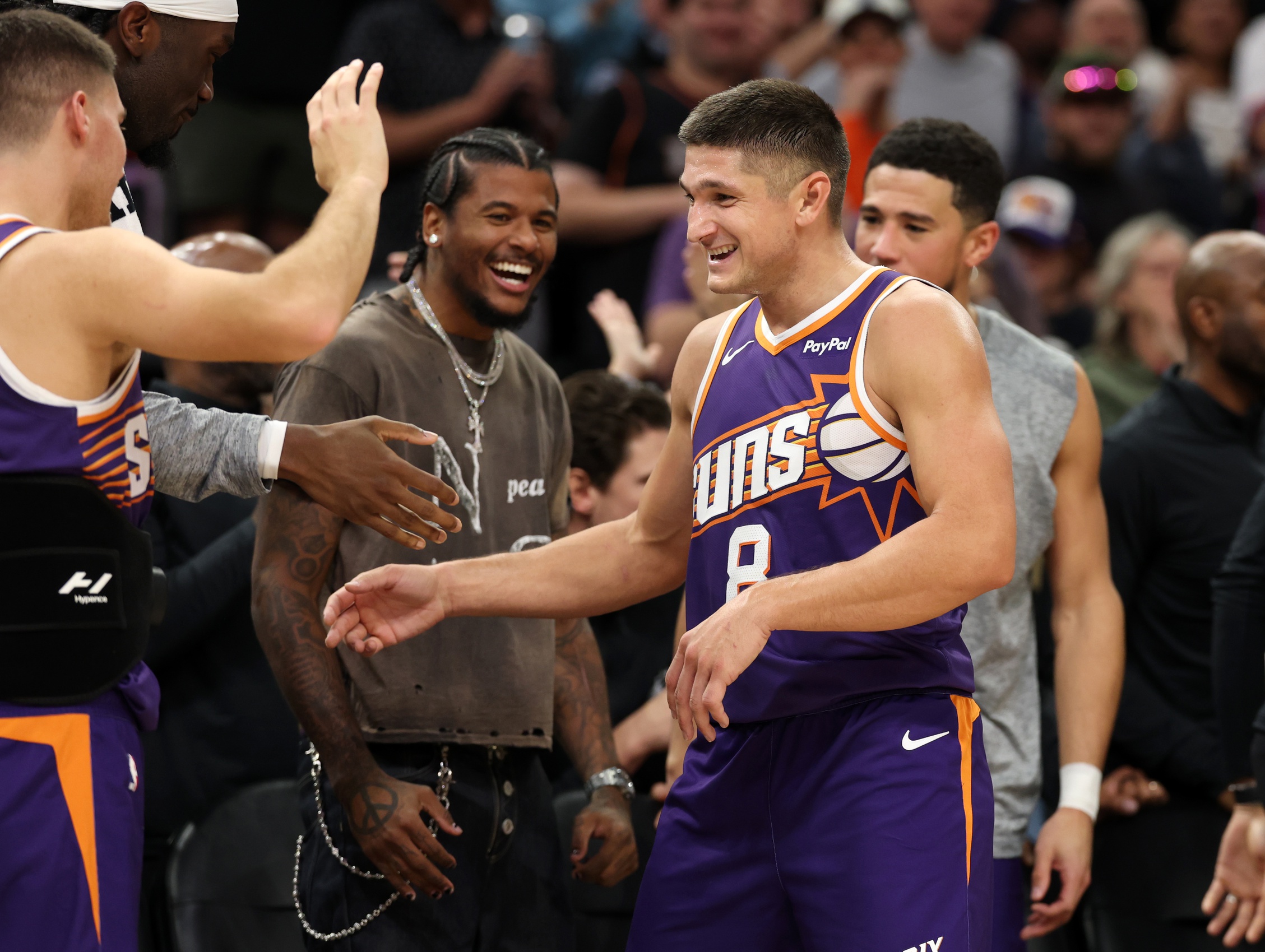 Nov 10, 2025; Phoenix, Arizona, USA; Phoenix Suns guard Grayson Allen (8) celebrates with teammates after being pulled from the game after setting the franchise record for three pointers in a game against the New Orleans Pelicans in the second half at the Mortgage Matchup Center. Mandatory Credit: Mark J. Rebilas-Imagn Images