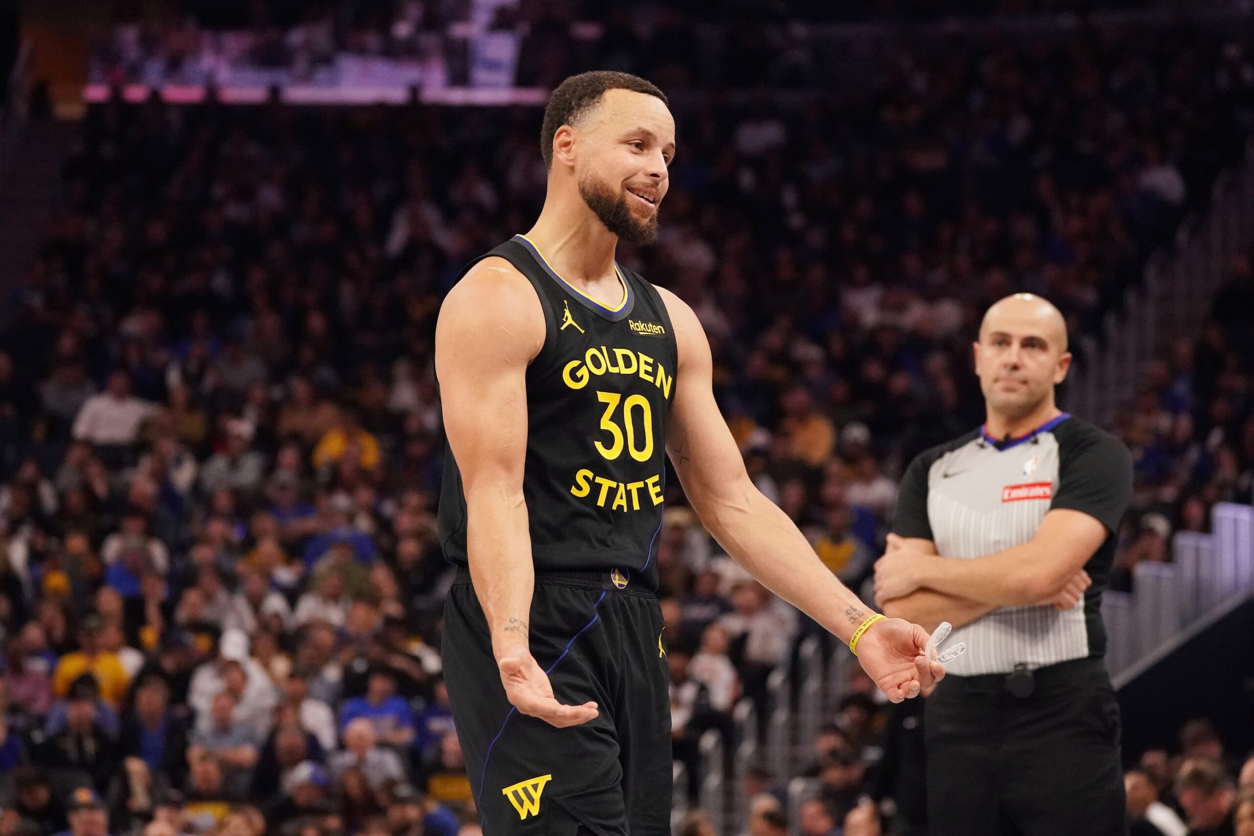 Nov 26, 2025; San Francisco, California, USA; Golden State Warriors guard Stephen Curry (30) talks to the Houston Rockets bench during a break in the action in the third quarter at Chase Center. Mandatory Credit: David Gonzales-Imagn Images